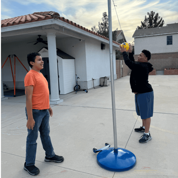 Two students play tether ball.