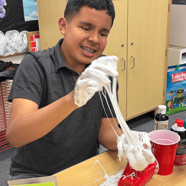 A student plays with slime.